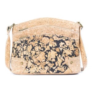 Patterned cork shoulder bag with zipper pockets.