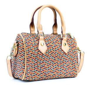Colorful patterned handbag with leather handles.