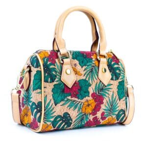 Floral handbag with tan leather handles.